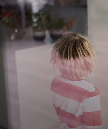 A kid behind a window